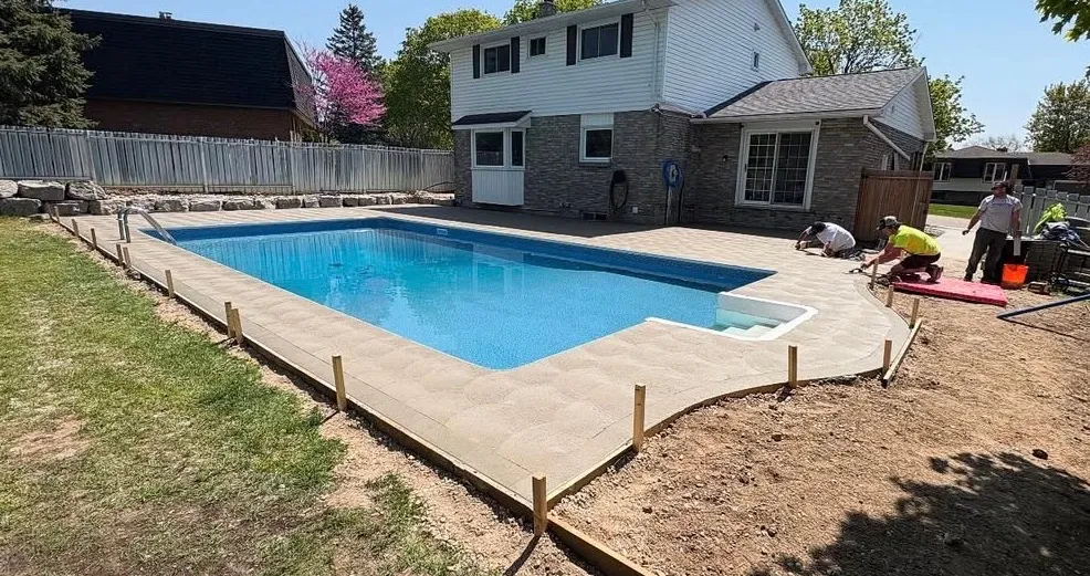 Concrete pool deck and patio poured by NMO Contracting in Oxford County