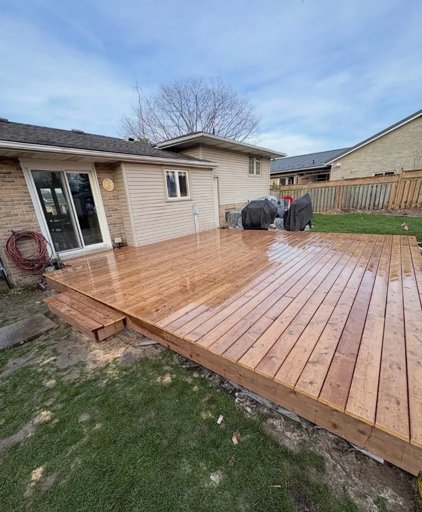 Custom wooden deck built behind a residential home
