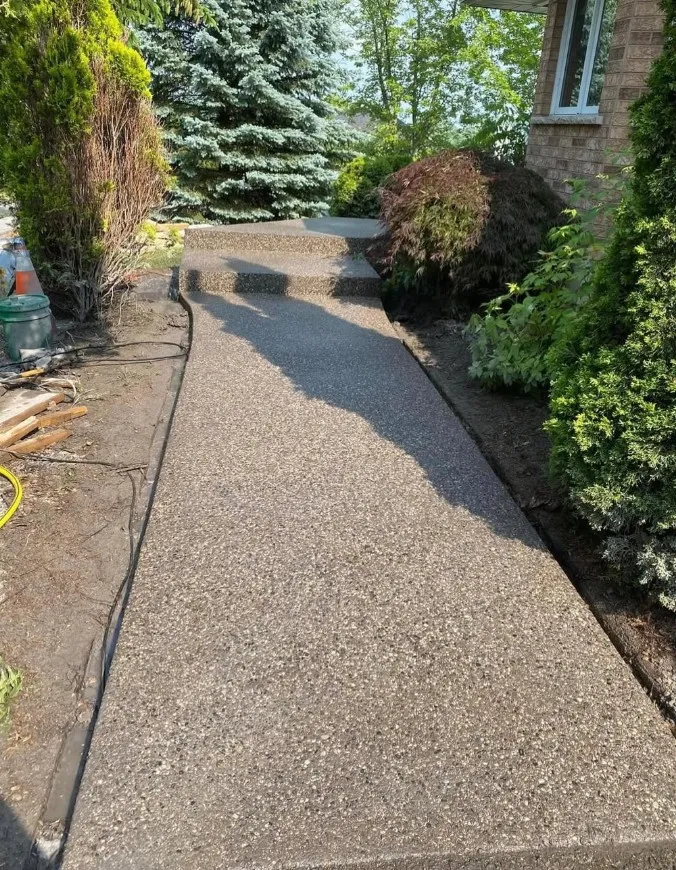 Exposed aggregate walkway leading to front steps of a home